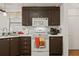 Kitchen with dark brown cabinets and white appliances at 6505 Raintree Ne Ln, Winter Haven, FL 33881
