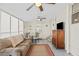 Spacious Florida room with comfy seating and ceiling fan at 6505 Raintree Ne Ln, Winter Haven, FL 33881