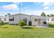 View of a white single-wide mobile home at 6505 Raintree Ne Ln, Winter Haven, FL 33881