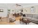 Relaxing living room featuring a comfortable recliner and sectional sofa at 6505 Raintree Ne Ln, Winter Haven, FL 33881