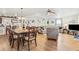 Open concept dining room with hardwood floors, a large table and access to the living room at 6505 Raintree Ne Ln, Winter Haven, FL 33881