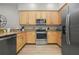 Modern kitchen with stainless steel appliances and light wood cabinets at 3050 Pirates Retreat Ct # 502, Kissimmee, FL 34747