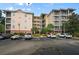 Condo building exterior with ample parking and surrounding landscaping at 3050 Pirates Retreat Ct # 502, Kissimmee, FL 34747