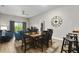 Bright dining area with a wooden table and six black chairs at 3050 Pirates Retreat Ct # 502, Kissimmee, FL 34747