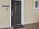 Condo entrance with a dark gray door and a welcome mat at 3050 Pirates Retreat Ct # 502, Kissimmee, FL 34747