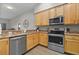 Modern kitchen featuring stainless steel appliances and light wood cabinets at 3050 Pirates Retreat Ct # 502, Kissimmee, FL 34747
