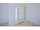 Front entry with tiled floor and white-trimmed door featuring a stained-glass design at 6556 Red Grange Blvd, Indian Lake Estates, FL 33855