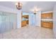 Spacious dining room with kitchen and backyard access at 6556 Red Grange Blvd, Indian Lake Estates, FL 33855