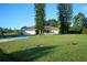 Single-story house with attached garage and a large grassy front yard at 6556 Red Grange Blvd, Indian Lake Estates, FL 33855