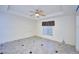 Well-lit bedroom with tile floors and window coverings at 6556 Red Grange Blvd, Indian Lake Estates, FL 33855