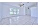 Bright living room with tile floors and large windows at 6556 Red Grange Blvd, Indian Lake Estates, FL 33855