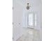 Bright entryway with tile flooring, a white door, and a chandelier at 6556 Red Grange Blvd, Indian Lake Estates, FL 33855