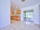 Dining area with tile floors and access to the kitchen and backyard patio at 6556 Red Grange Blvd, Indian Lake Estates, FL 33855