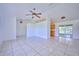 Spacious living area with tile floors and open layout to kitchen and dining areas at 6556 Red Grange Blvd, Indian Lake Estates, FL 33855