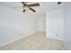 Simple bedroom with tile floors and ceiling fan at 6556 Red Grange Blvd, Indian Lake Estates, FL 33855