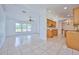 Kitchen with wood cabinets, granite countertops and tile flooring at 6556 Red Grange Blvd, Indian Lake Estates, FL 33855