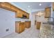 Kitchen features wood cabinets, granite countertops, and tile flooring at 6556 Red Grange Blvd, Indian Lake Estates, FL 33855