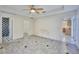 Large bedroom with tile floors and access to bathroom and kitchen at 6556 Red Grange Blvd, Indian Lake Estates, FL 33855