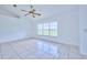 Bright living room with tile flooring, vaulted ceiling and large window at 6556 Red Grange Blvd, Indian Lake Estates, FL 33855