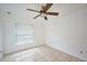 Bedroom with ceiling fan and window coverings at 6556 Red Grange Blvd, Indian Lake Estates, FL 33855