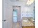 Guest bathroom with granite vanity and tile floor at 6556 Red Grange Blvd, Indian Lake Estates, FL 33855