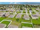 Aerial view of community with lake and houses at 6048 Forest Ridge Ln, Winter Haven, FL 33881