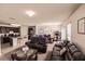 Open concept living room and kitchen with dark brown leather furniture at 6048 Forest Ridge Ln, Winter Haven, FL 33881