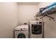 Laundry room with washer, dryer, and shelving at 6048 Forest Ridge Ln, Winter Haven, FL 33881