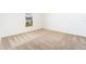 Bright bedroom with neutral carpeting and large window at 3816 Corsican Pl, Lake Alfred, FL 33850