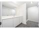 Bathroom with white cabinets, a large mirror, and a walk-in shower at 3816 Corsican Pl, Lake Alfred, FL 33850