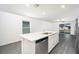 Open concept kitchen with stainless steel appliances, granite countertops and island at 3816 Corsican Pl, Lake Alfred, FL 33850