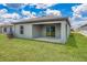 Home with covered patio and grassy backyard at 3816 Corsican Pl, Lake Alfred, FL 33850