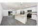 Open concept kitchen with island, stainless steel appliances, and granite countertops at 3816 Corsican Pl, Lake Alfred, FL 33850