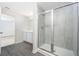 Modern bathroom with gray wood-look floors and a glass shower at 3816 Corsican Pl, Lake Alfred, FL 33850