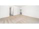 Well-lit bedroom featuring neutral carpeting and access to hallway bathroom at 3816 Corsican Pl, Lake Alfred, FL 33850