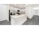 Modern kitchen boasts stainless steel appliances, granite countertops, and an island at 3816 Corsican Pl, Lake Alfred, FL 33850