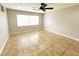 Spacious bedroom with tile flooring and ceiling fan at 1723 Rotary Dr, Lakeland, FL 33801