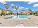 Community pool with lounge chairs and surrounding buildings at 5333 River Rock Rd, Lakeland, FL 33809