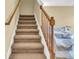 Carpeted staircase with wooden railing and access to living area at 5333 River Rock Rd, Lakeland, FL 33809