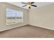 Bright bedroom featuring large window with blinds and ceiling fan at 5333 River Rock Rd, Lakeland, FL 33809