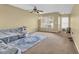 Spacious living room with neutral carpeting and a ceiling fan at 5333 River Rock Rd, Lakeland, FL 33809
