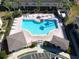 Aerial view of community pool with lounge chairs and surrounding buildings at 5333 River Rock Rd, Lakeland, FL 33809