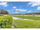 Backyard view with pond, landscaping, and highway at 5333 River Rock Rd, Lakeland, FL 33809