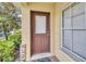 Front door entrance with window and landscaping at 5333 River Rock Rd, Lakeland, FL 33809