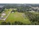 Aerial view of property with large lot, pond, and nearby buildings at 1440 Duff Rd, Lakeland, FL 33810