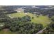 Aerial view of property with large lot, pond, and nearby buildings at 1440 Duff Rd, Lakeland, FL 33810