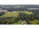 Aerial view showing property with a pond and surrounding trees at 1440 Duff Rd, Lakeland, FL 33810