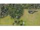 Aerial view of property showing a home, pond and open land at 1440 Duff Rd, Lakeland, FL 33810