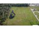 Aerial view of a large lot with pond and mature trees at 1440 Duff Rd, Lakeland, FL 33810