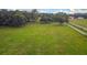 Aerial view of a vacant lot with grassy field and distant buildings at 1440 Duff Rd, Lakeland, FL 33810
